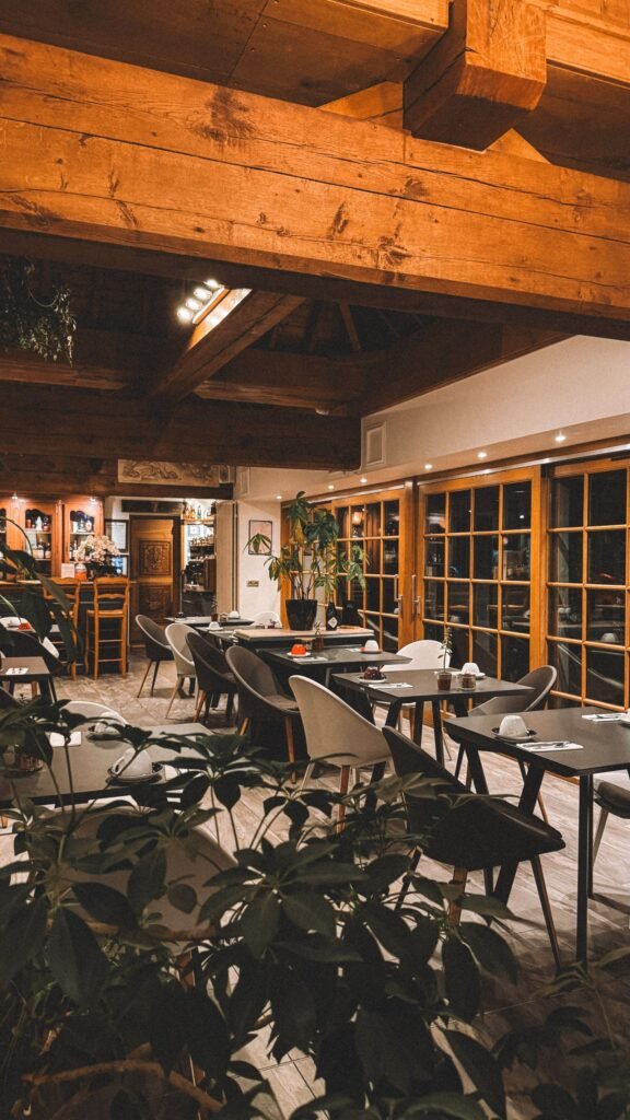 Interior acogedor de un restaurante con vigas de madera y mesas puestas